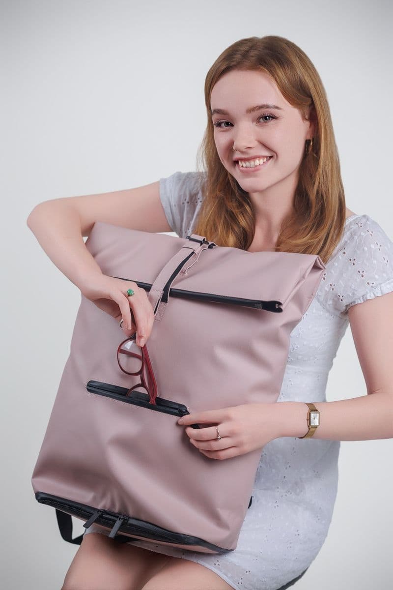Model showing NORJ pink backpack pocket detail